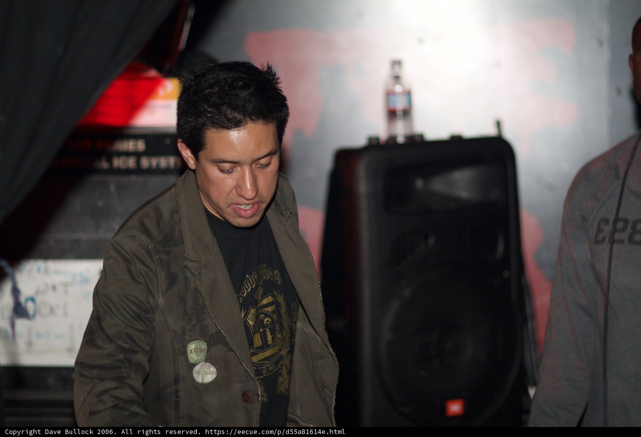 Man Delivering a Speech in Front of a Speaker