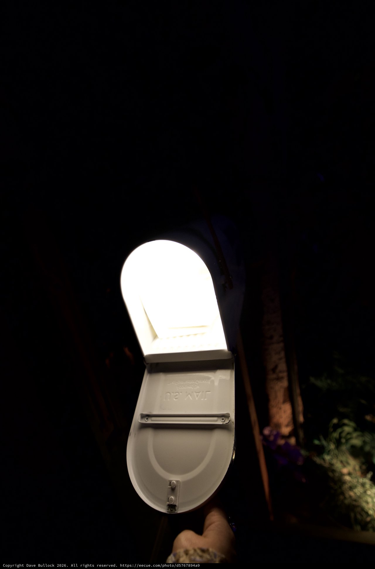 Illuminated Mailbox Against Dark Night Sky