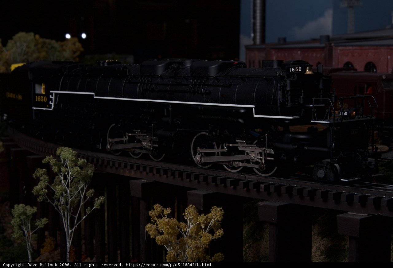 Black Locomotive Chugging Along the Railway