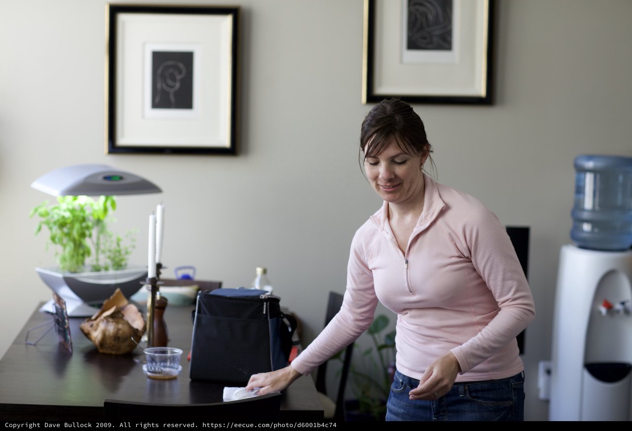 Woman Tidying Up a Modern Home Interior