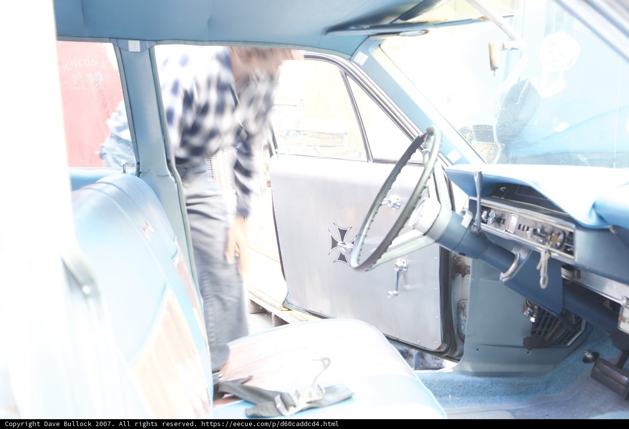 Man inspecting the interior of a car