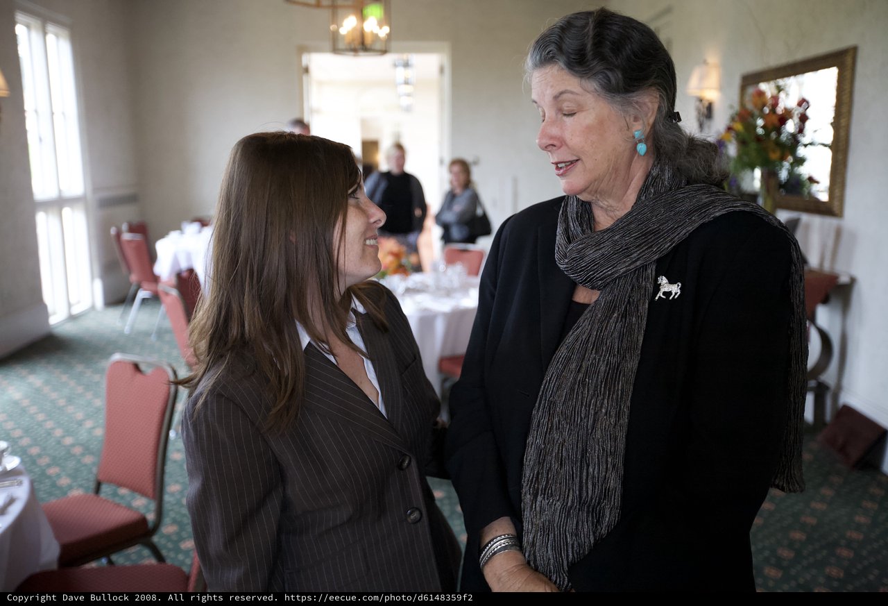 Two Women Share a Quiet Moment at Memorial Gathering