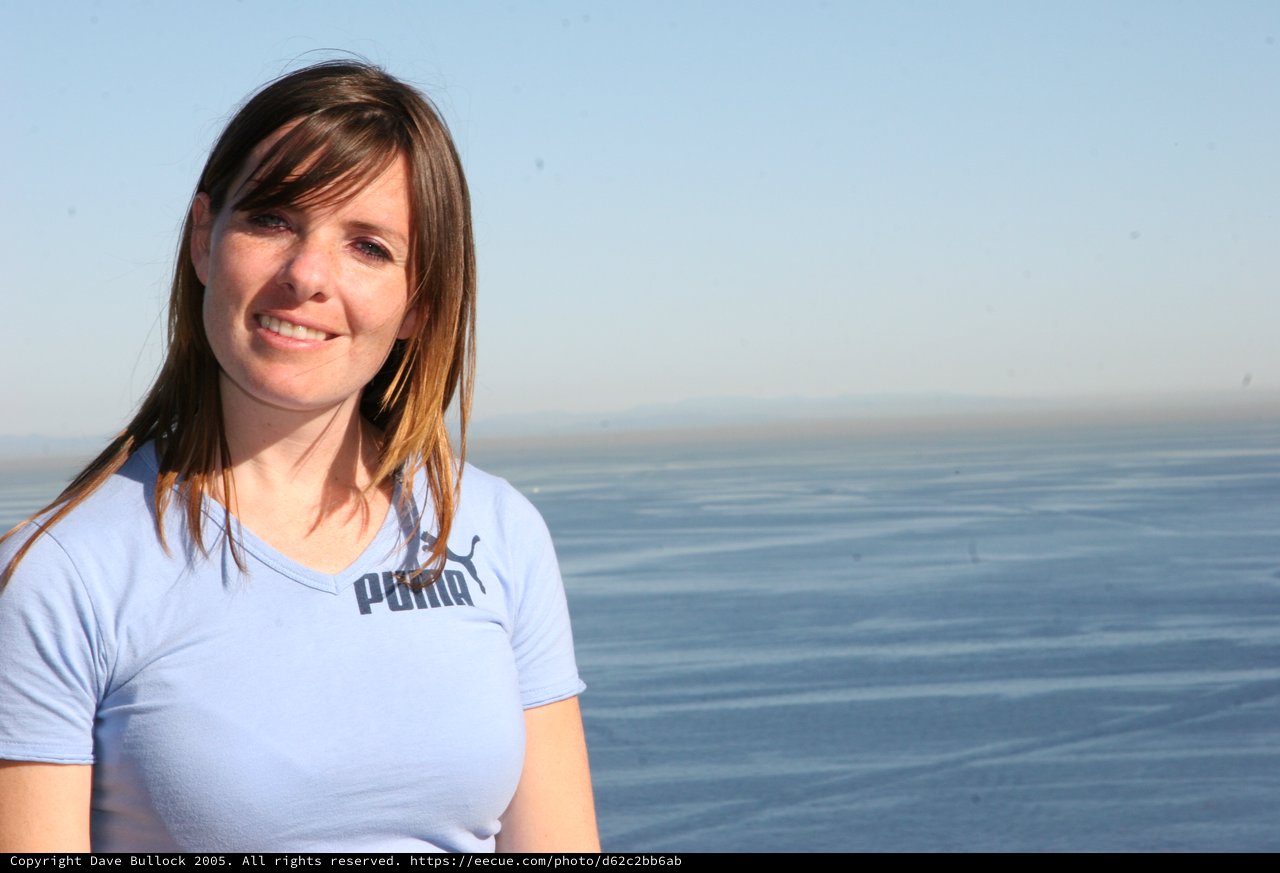Smiling Woman by the Sea at Golden Hour