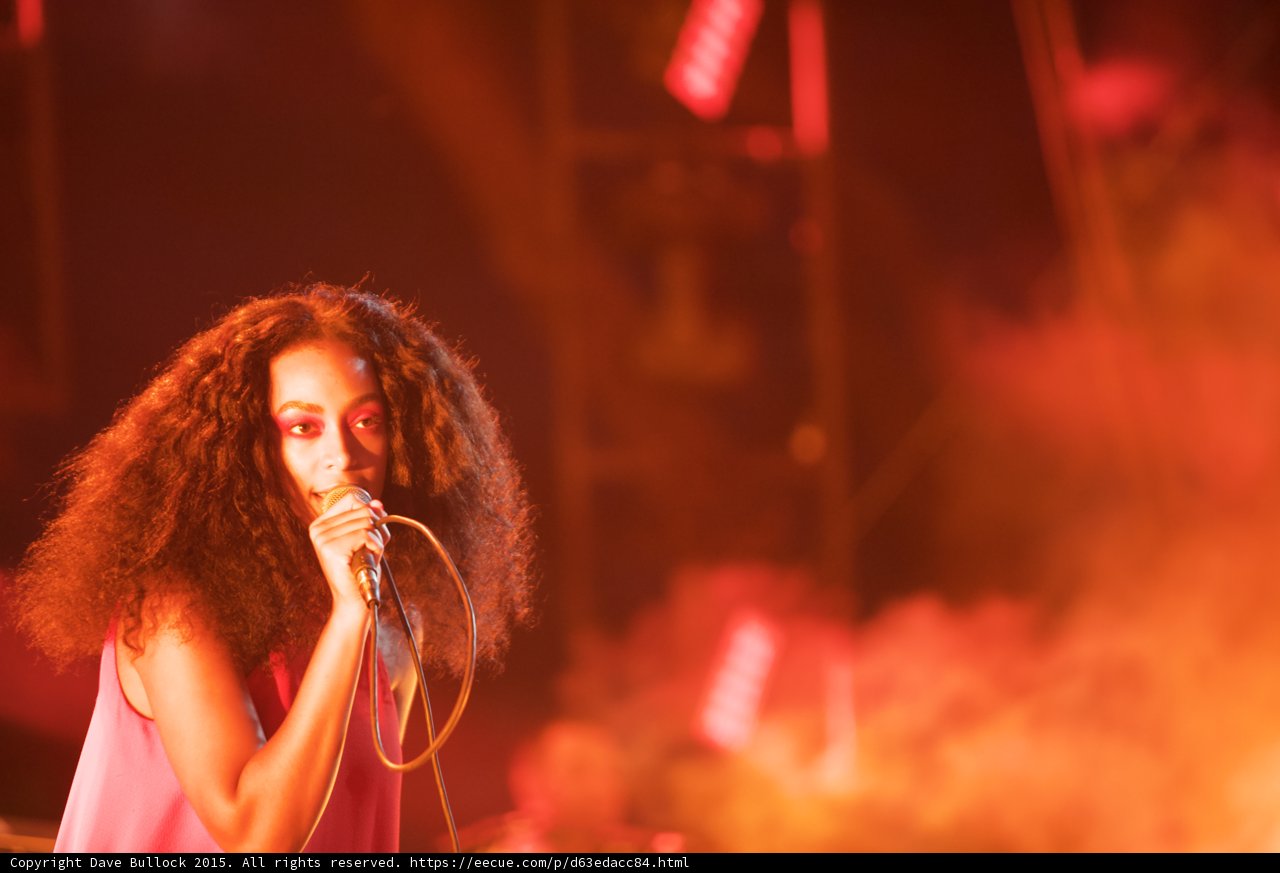 Solange Portrait Looking Forward Singing Red Orange Smoke