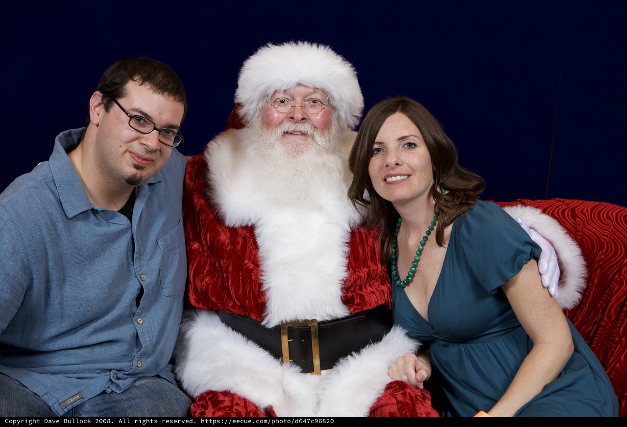 Adults Posing with Santa Claus at Christmas Party