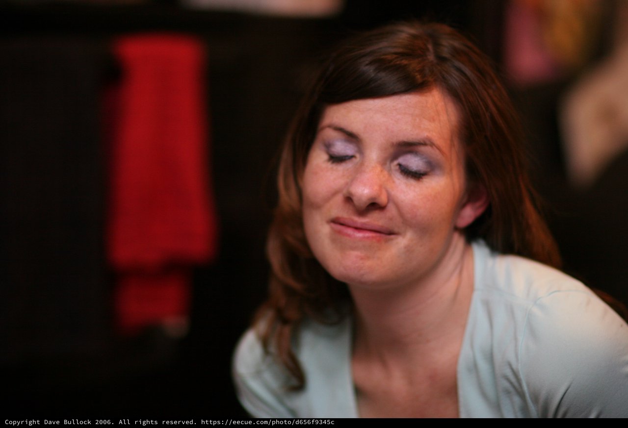 Contemplative Woman with Eyes Closed in Low Light
