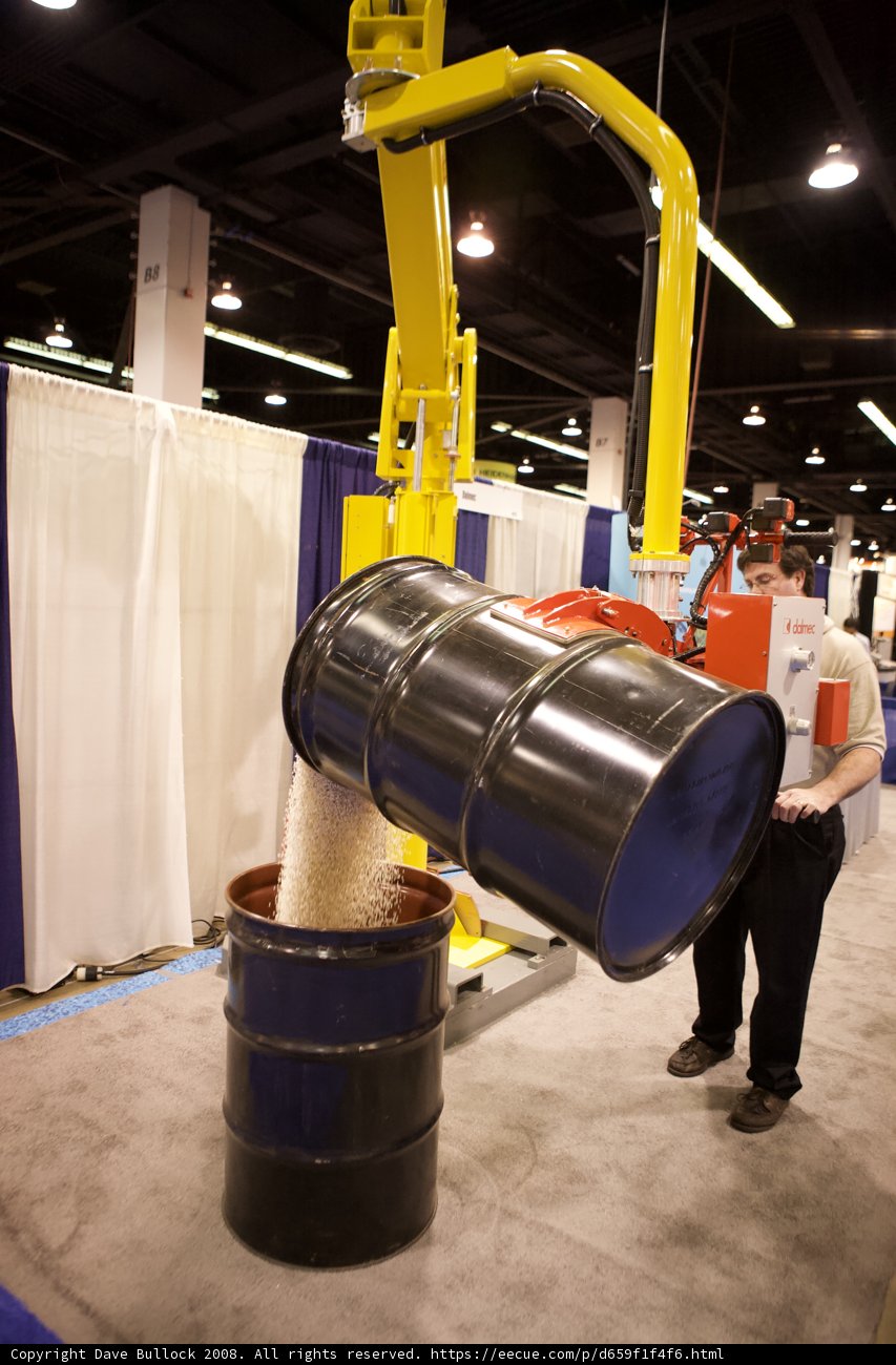 Man Standing Next to a Barrel at the 2008 Robot Automation Show