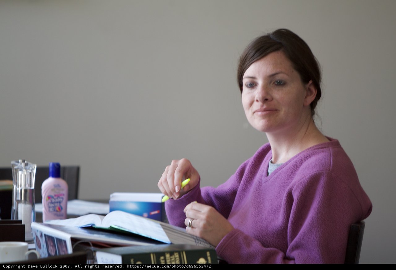 Woman Studying with Highlighter at Desk