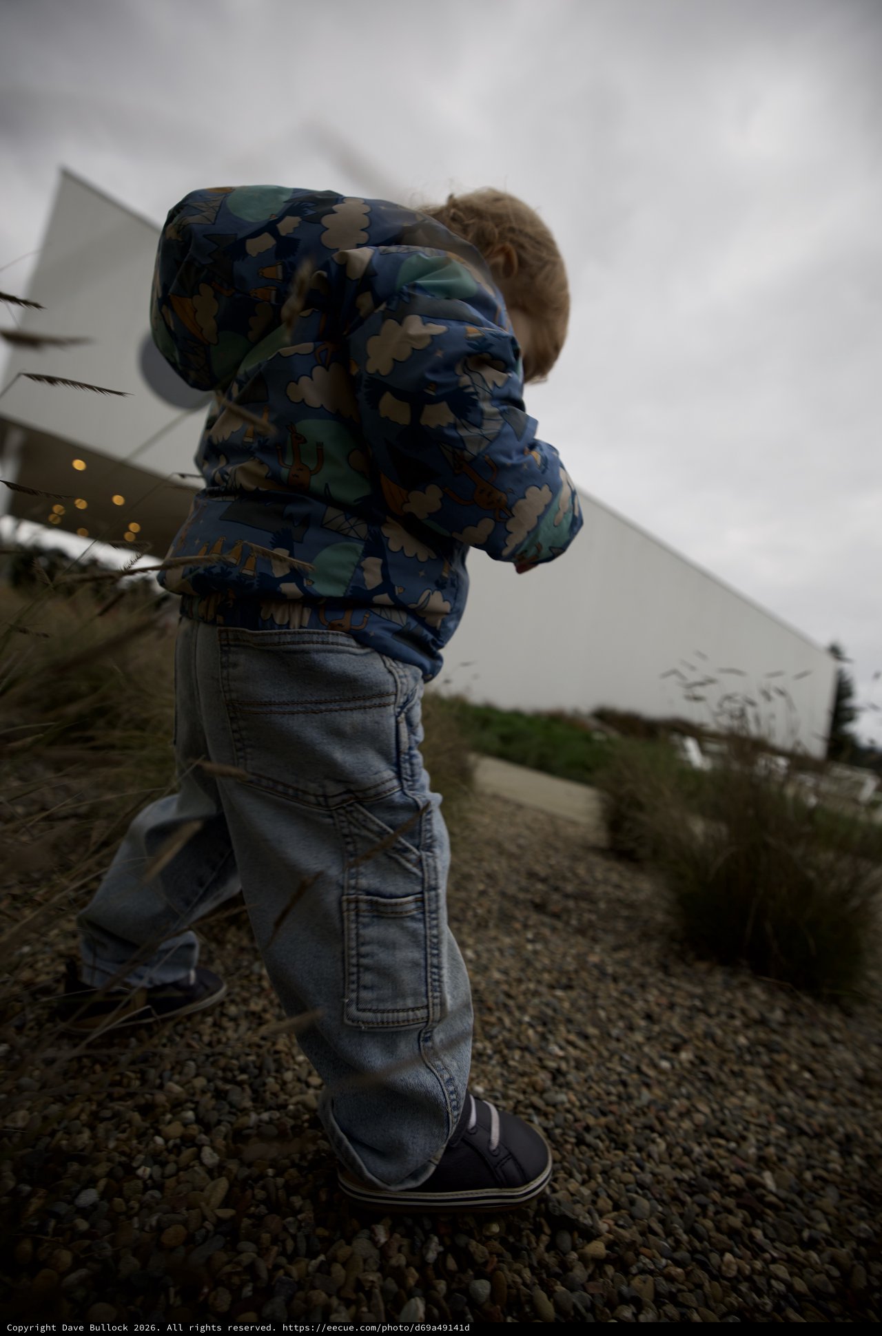 Young Child Running on Gravel Path at Dusk