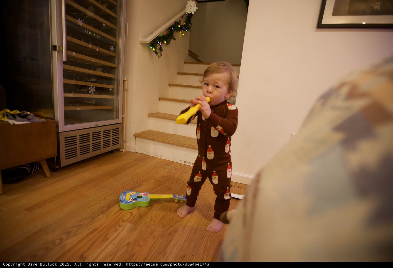 Toddler Playing Yellow Recorder on Christmas Morning