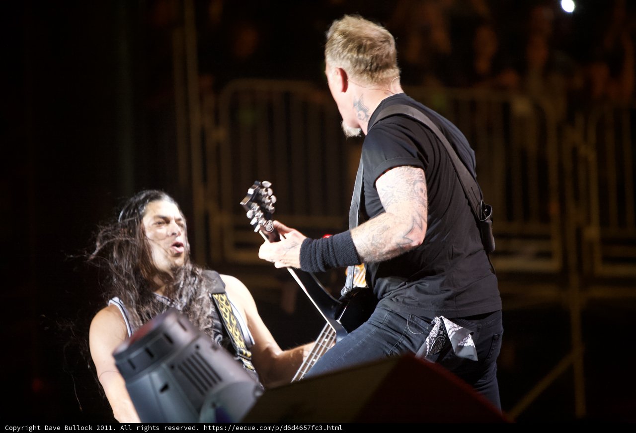 Rocking the Stage: Robert Trujillo and a fellow guitarist perform at the Big Four Festival