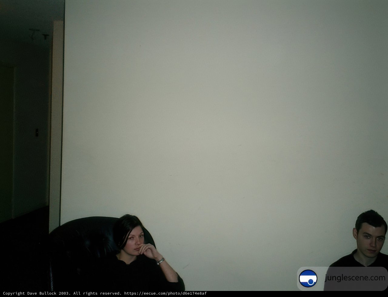 A Portrait of Two People in a White-Walled Room