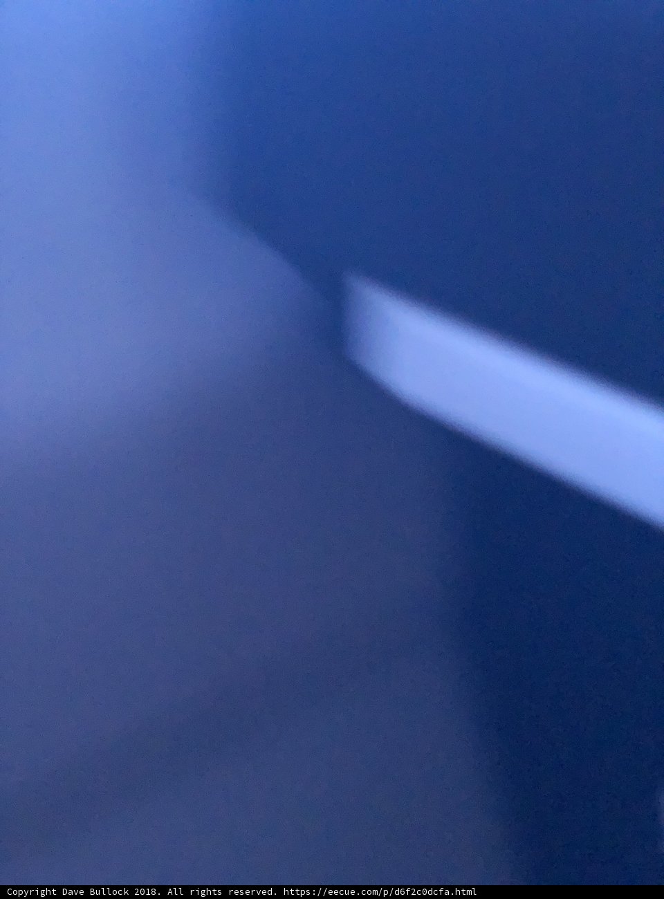 Blurry White Cross in Darkness