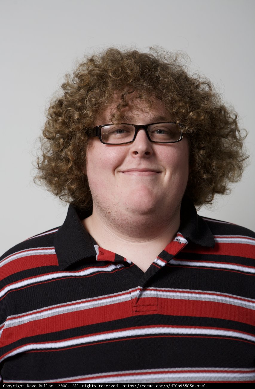 Happy Man with Curly Hair and Glasses