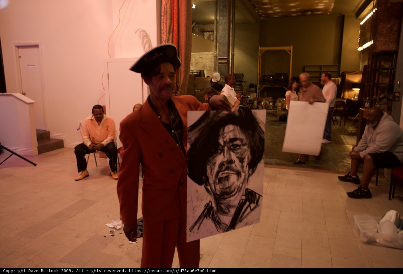 Man Showing Drawing of Another Man