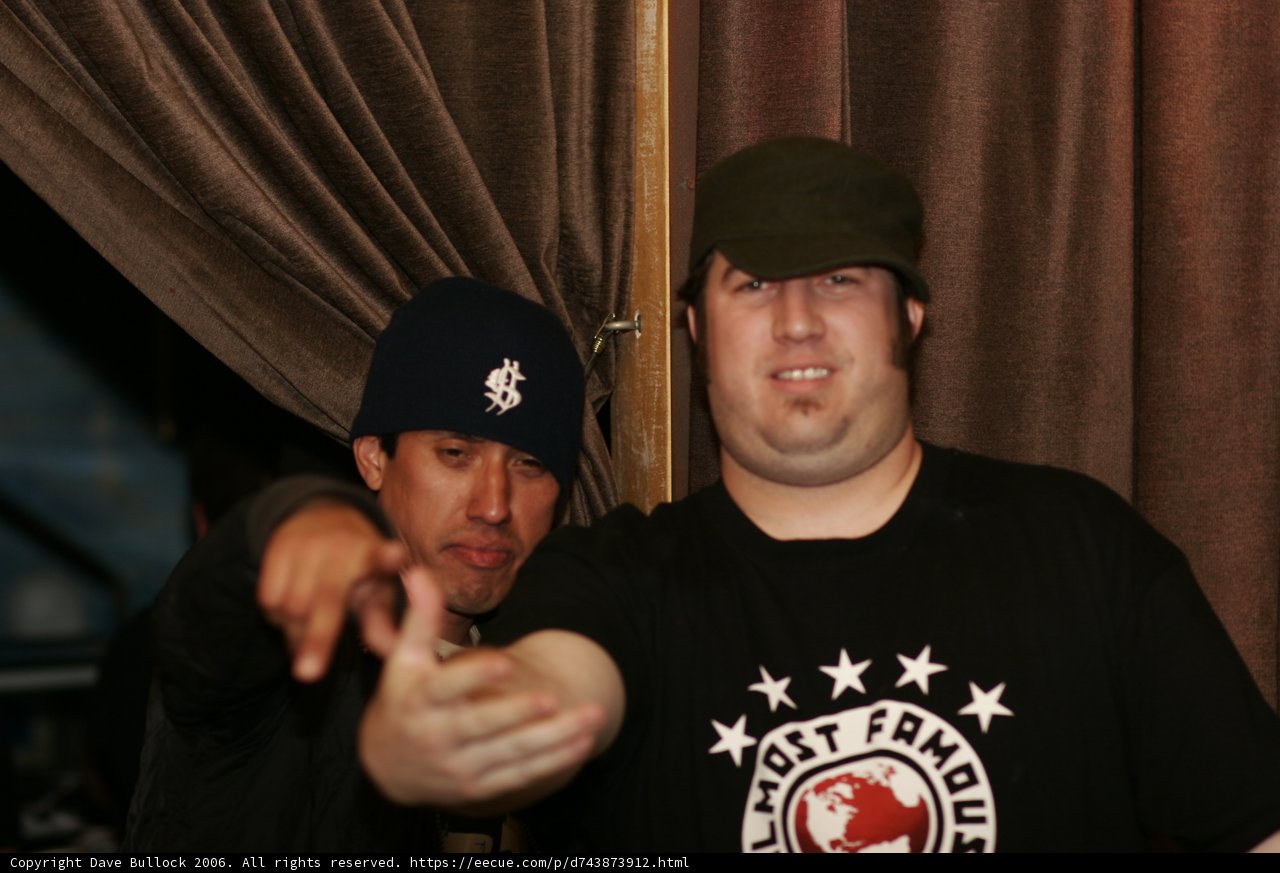 Two Men Strike a Pose in Baseball Caps and T-Shirts