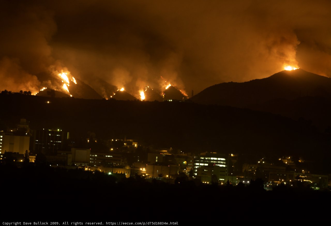 Blaze Engulfs City and Mountains