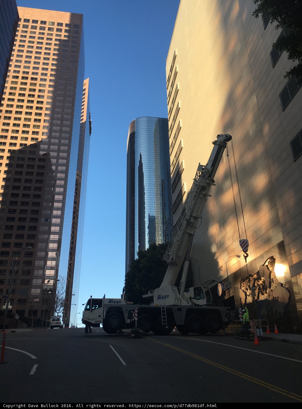 Construction Crane Lifting Equipment onto Office Building in Urban Metropolis