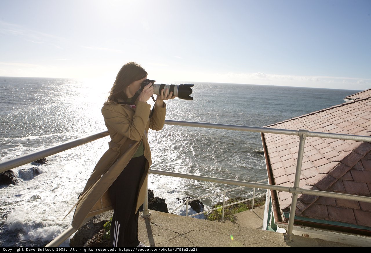 Photographer Capturing the Pacific Ocean at Cliff's Edge