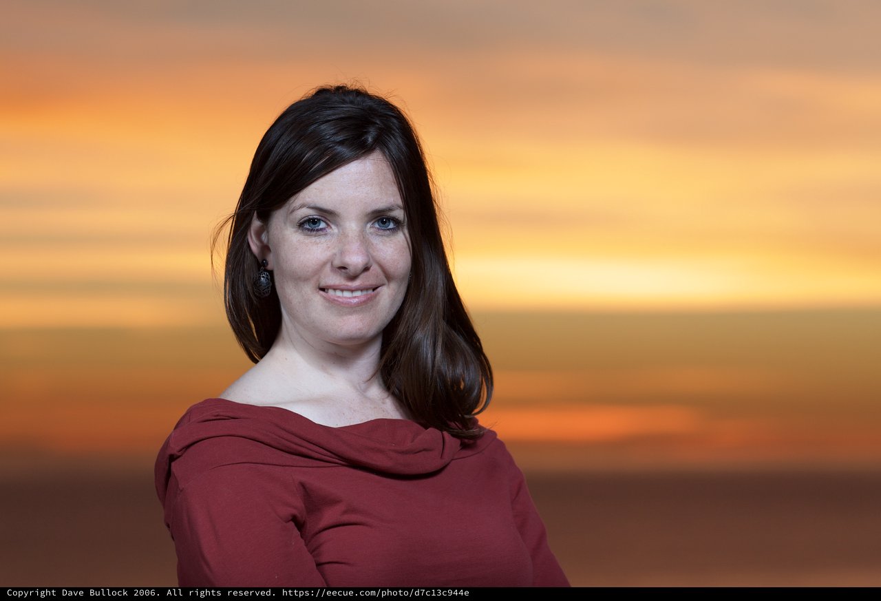 Portrait of a Woman Against a Vibrant Sunset Sky
