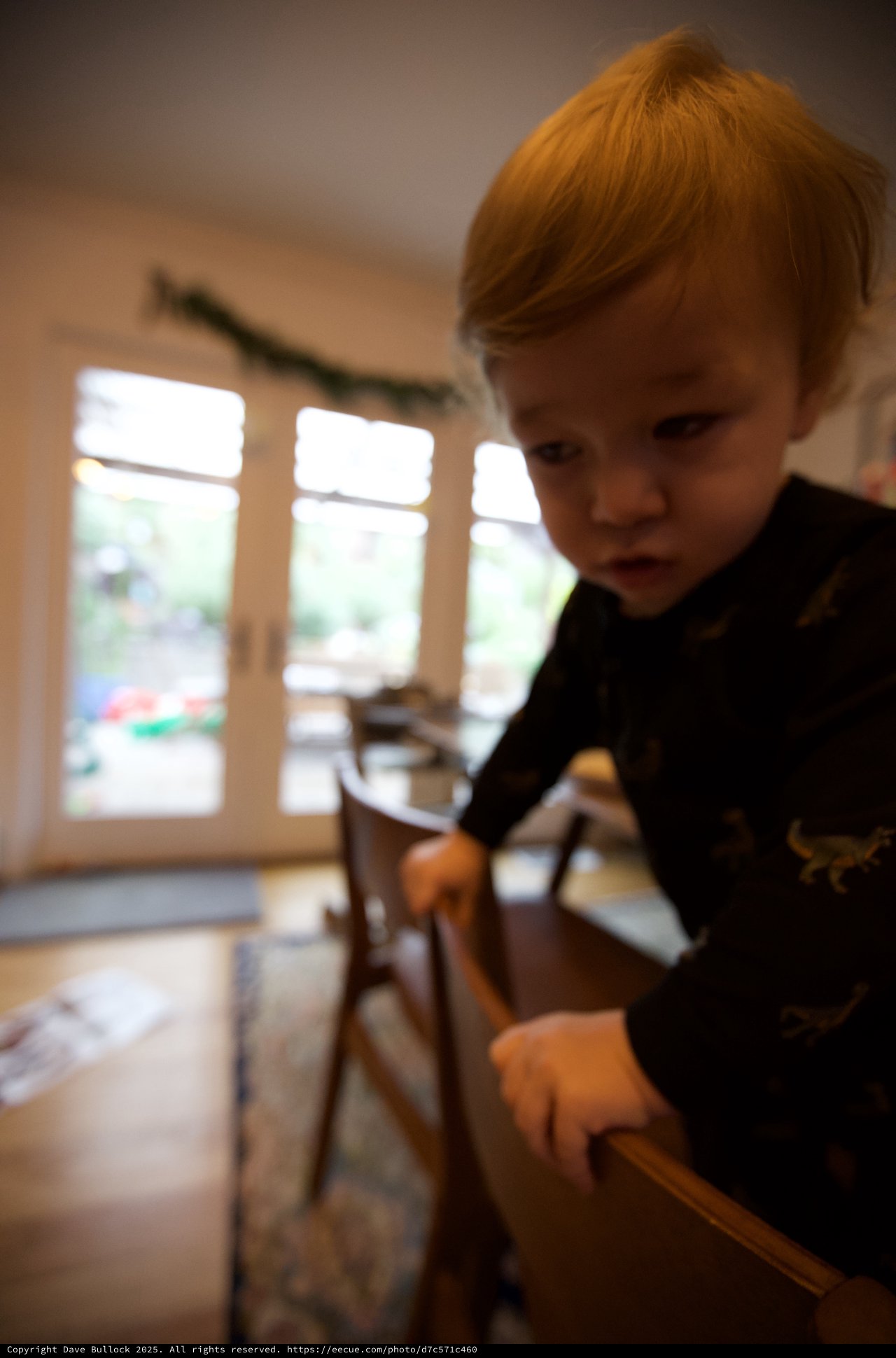 Curious Toddler with Red Hair Exploring at Home
