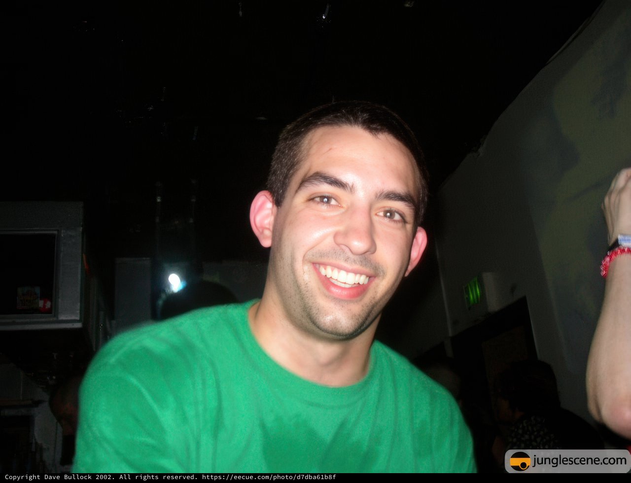 Green Shirted Man Smiling in the City