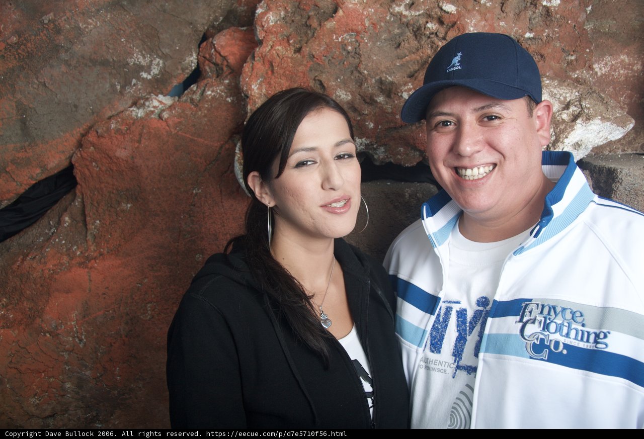 Smiling Couple Poses Next to Wall