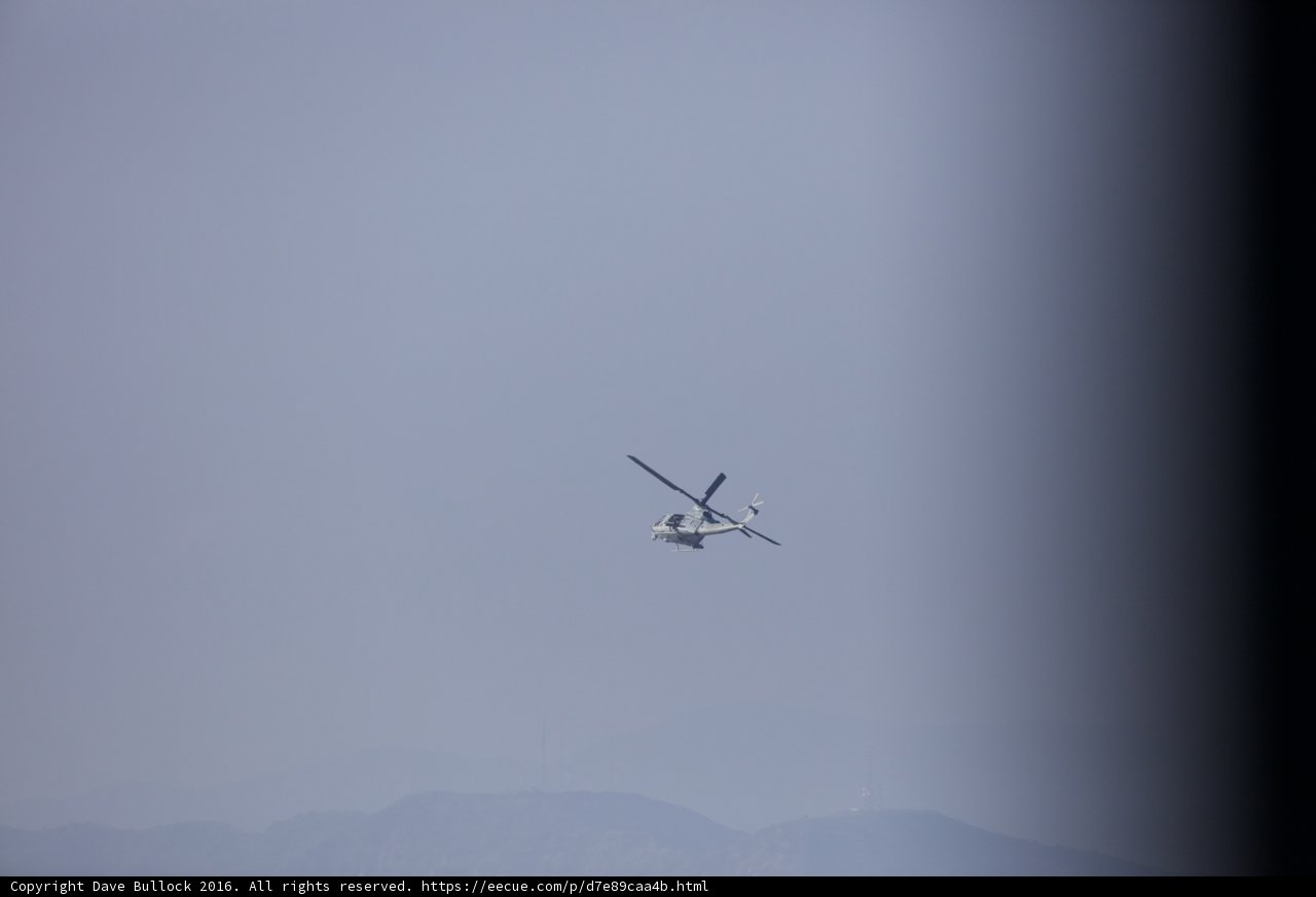 Helicopter Soaring Over Mountain Range