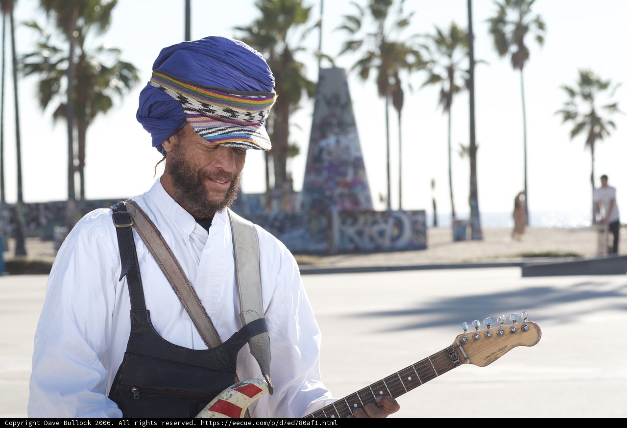 Turbaned musician with an acoustic guitar