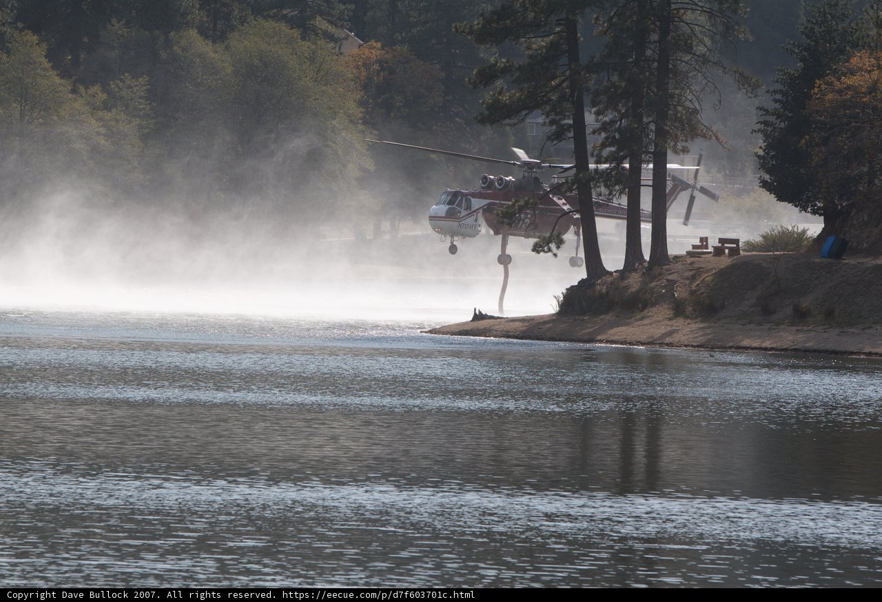Helicopter surveillance over a misty lake