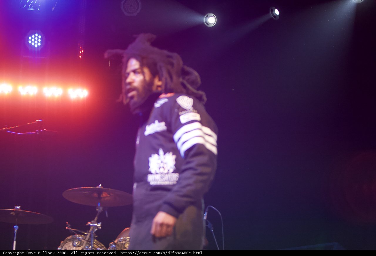 Dreadlocked performer under the spotlight