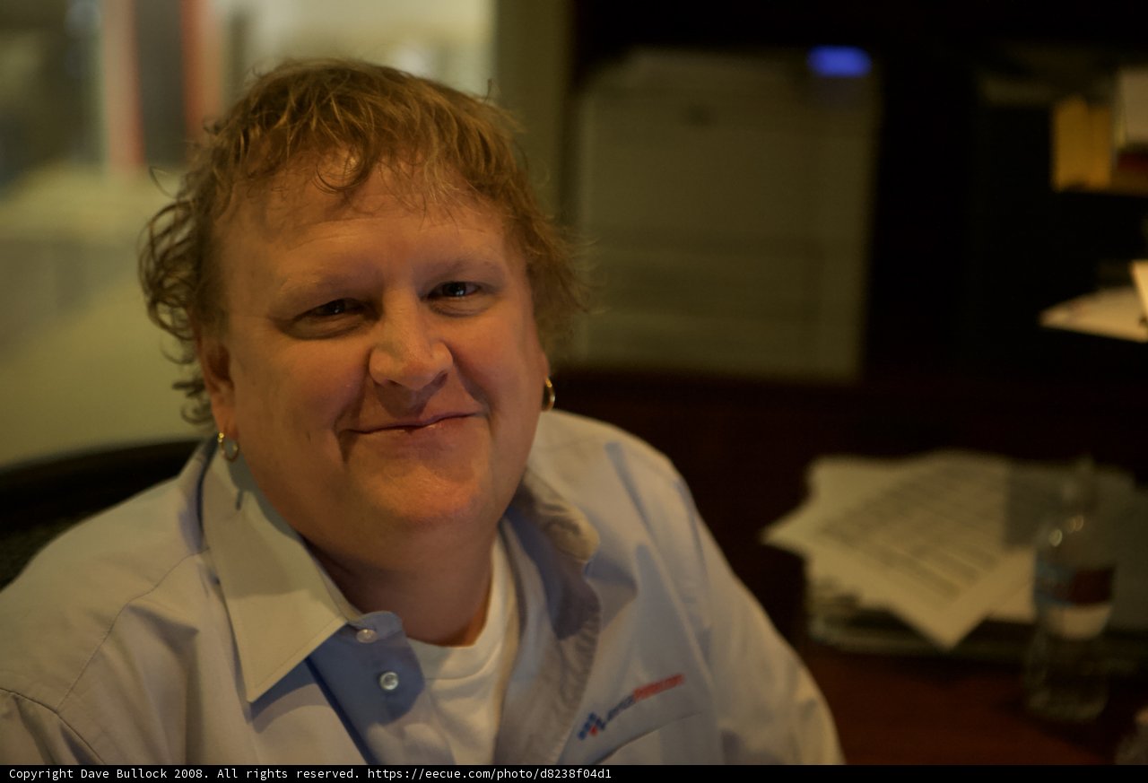 Man in Blue Shirt Working at Desk