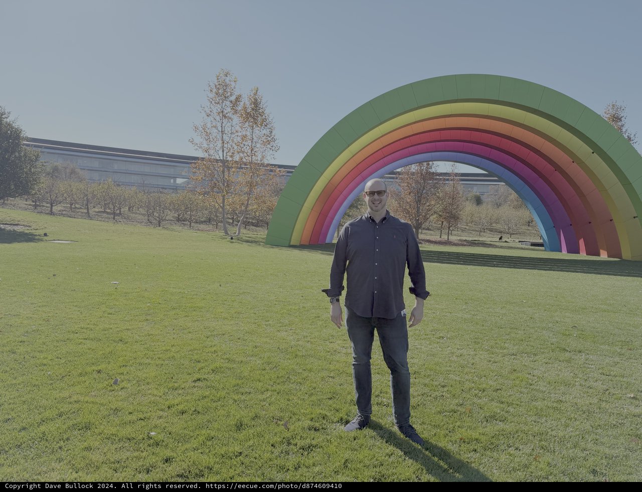 Man Posing with Rainbow Art Installation