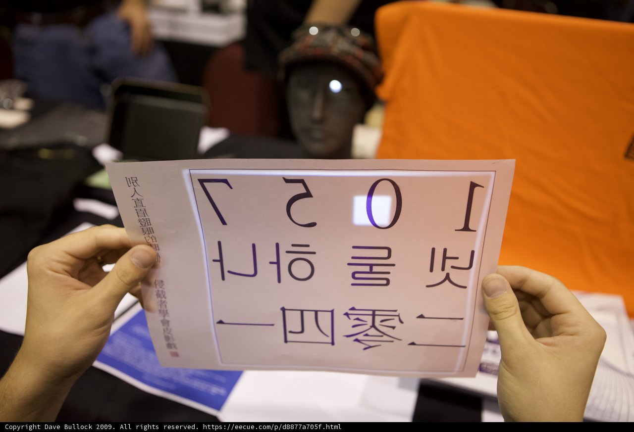 A Woman Holds Up a Handwritten Document Sign