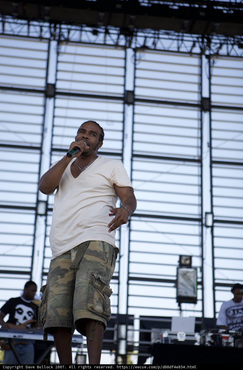 Entertainer Pharoahe Monch on stage in camo shorts and white shirt at Coachella 2007