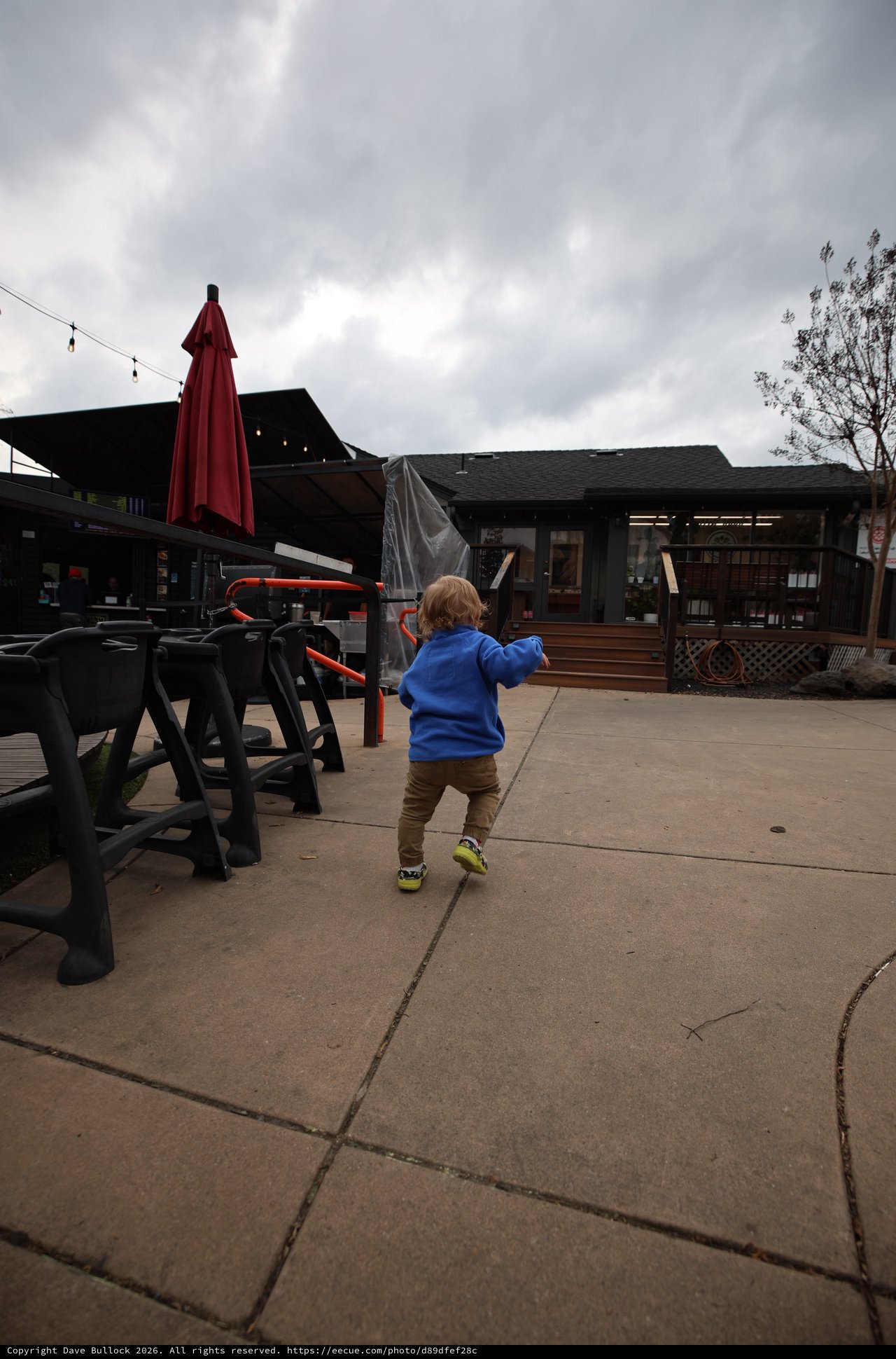 Toddler Exploring Outdoor Patio on Cloudy Day
