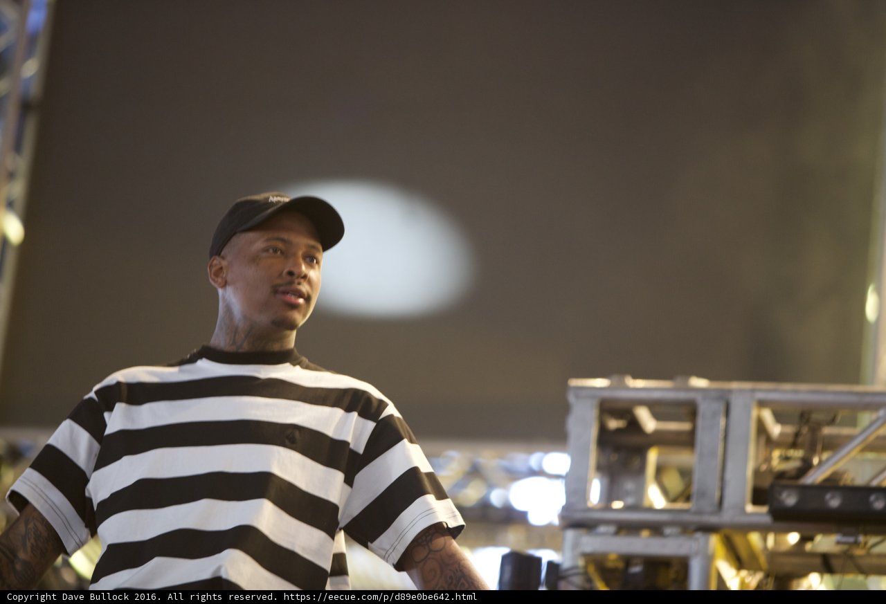YG takes the stage in bold stripes and a cap