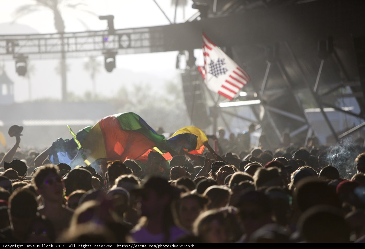 Concert-goers Wave Flags in Unison