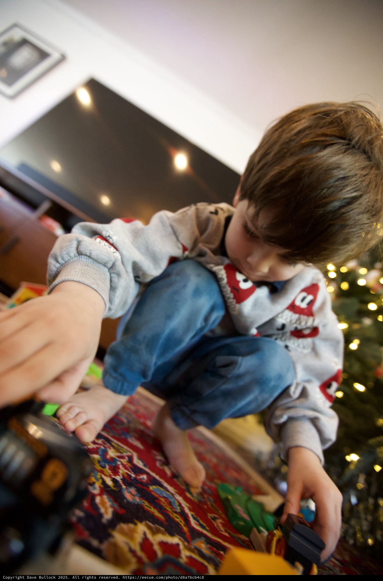 Child Opening Christmas Presents on Holiday Morning