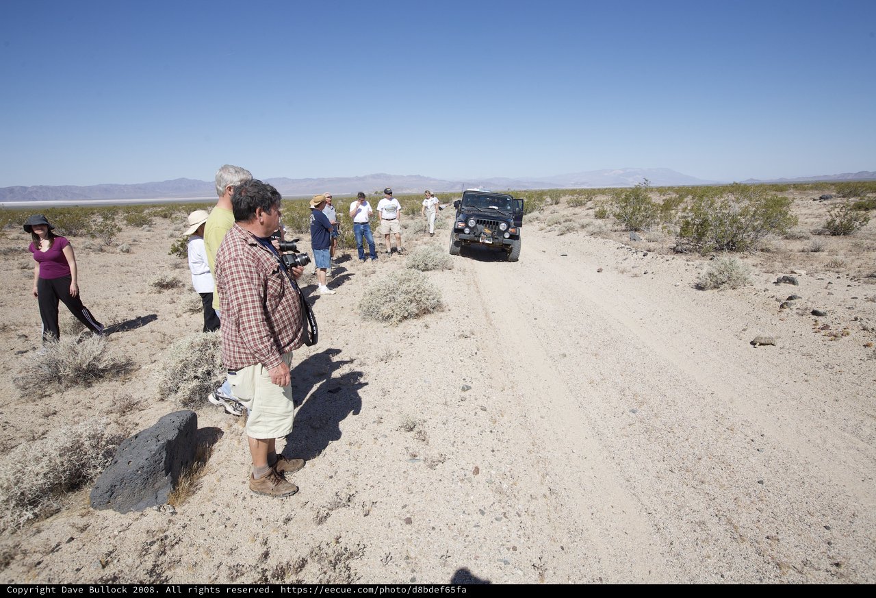 Desert Explorers Watch Jeep Navigate Dusty Trail