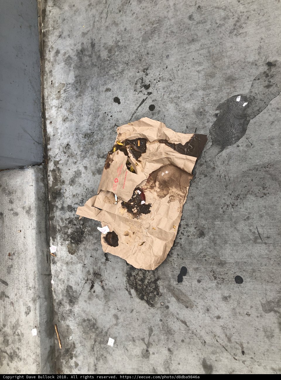 Discarded Trash Marred by Tar Stains