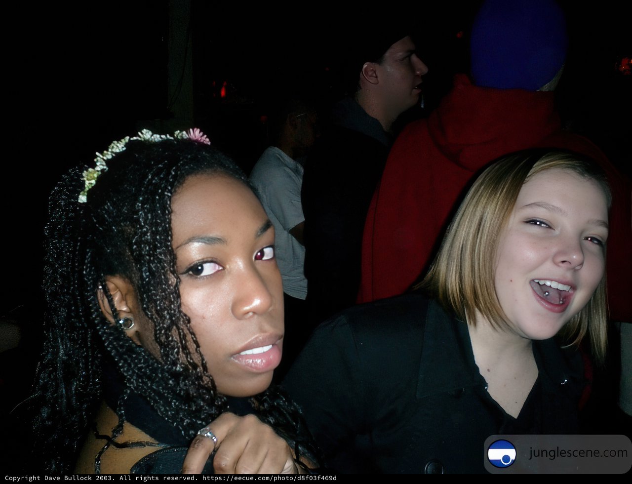 Two Women Strike a Pose at a Party