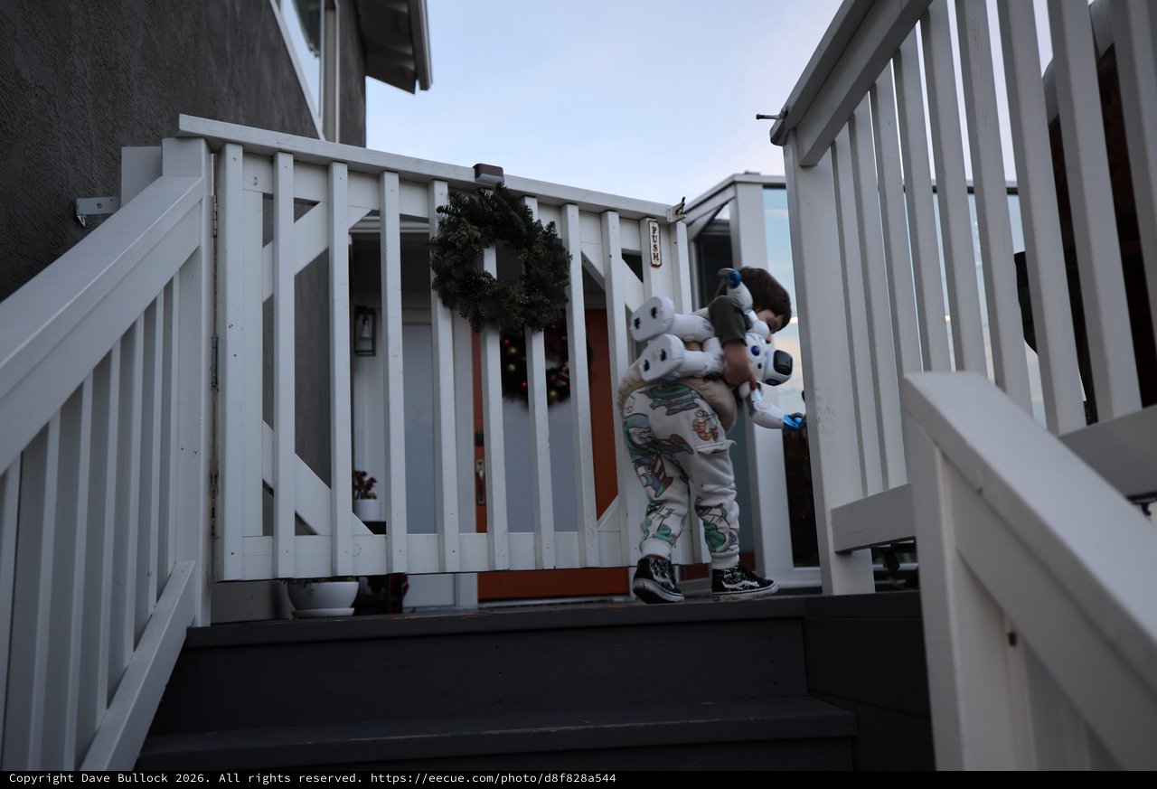 Child with Stuffed Animal on Winter Porch at Dusk