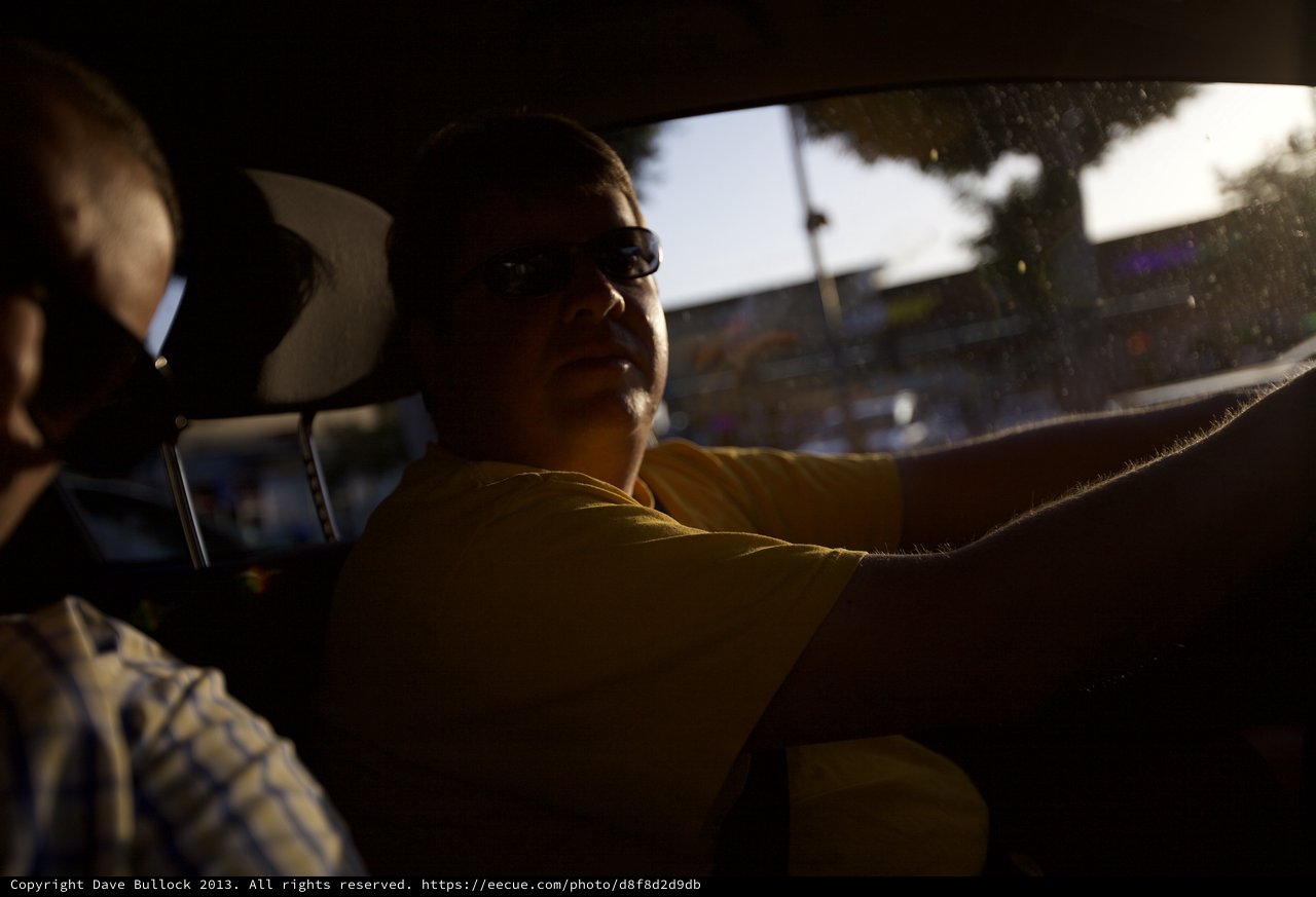 Silhouetted Driver in Golden Hour Urban Traffic