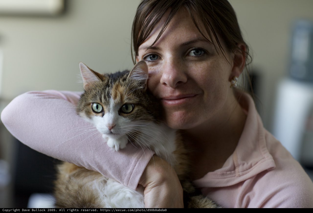 Woman and Her Calico Cat Share a Tender Moment