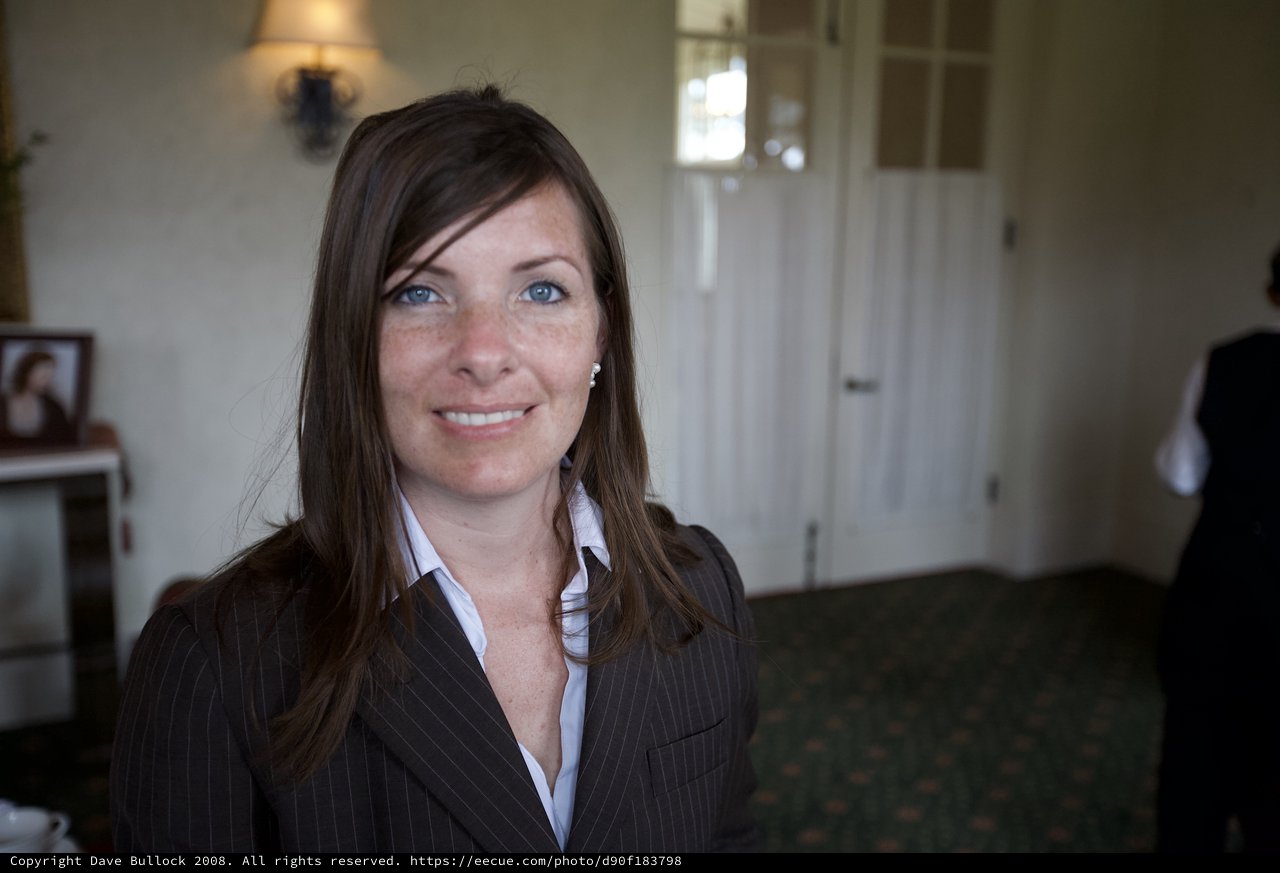 Professional Woman Smiling at a Funeral Reception