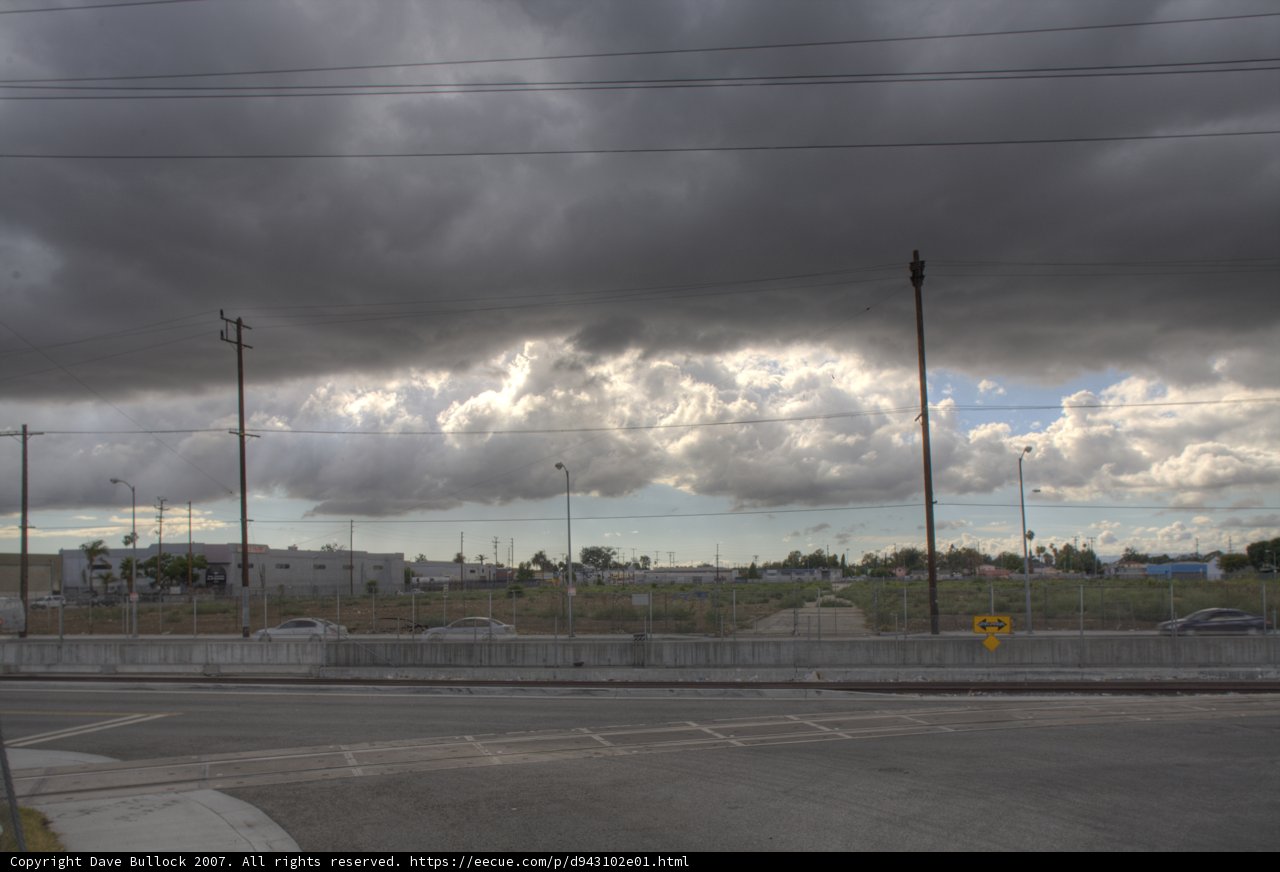 Cloudy Sky over City Streets with Power Lines