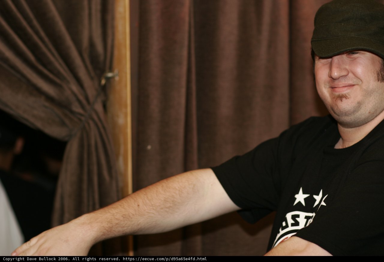 Black Shirted Man in Baseball Cap