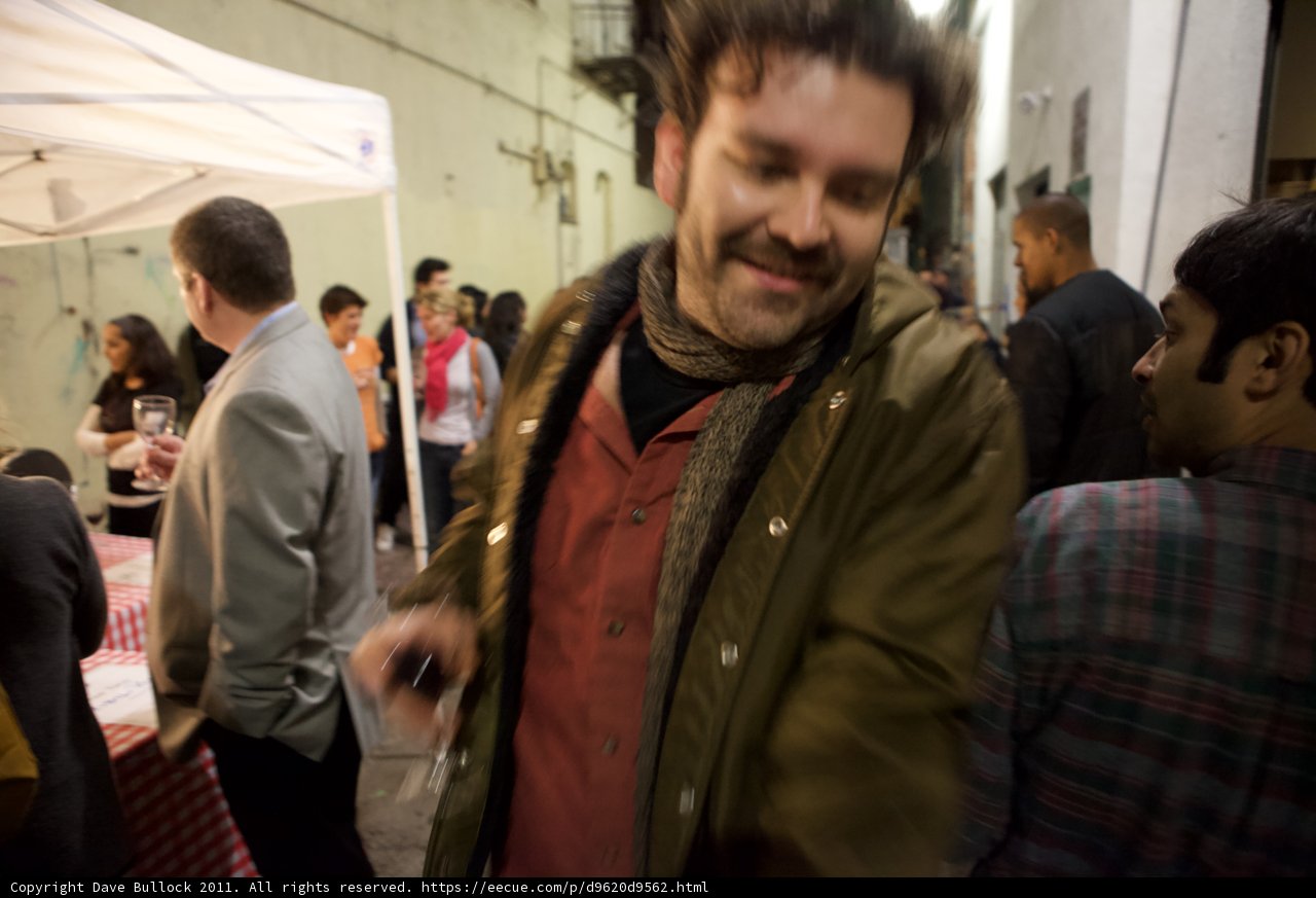Smiling man stands out at Plata Wine Party