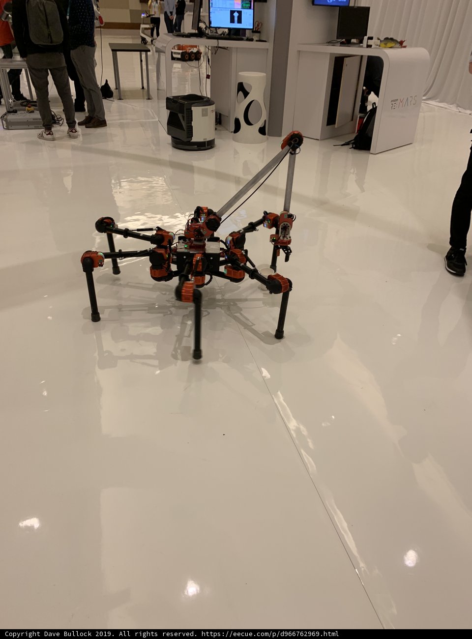 Futuristic Robot on Display with a Captivated Audience